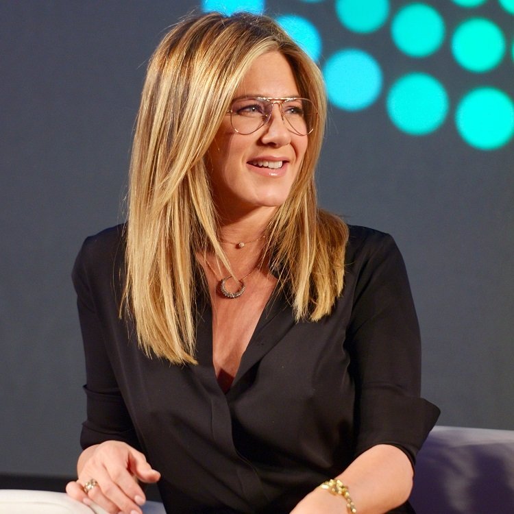 Corte de cabello mujer de 50 años con rostro redondo y lentes estilo jennifer aniston